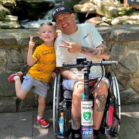 Matt Buyten smiling with a young supporter